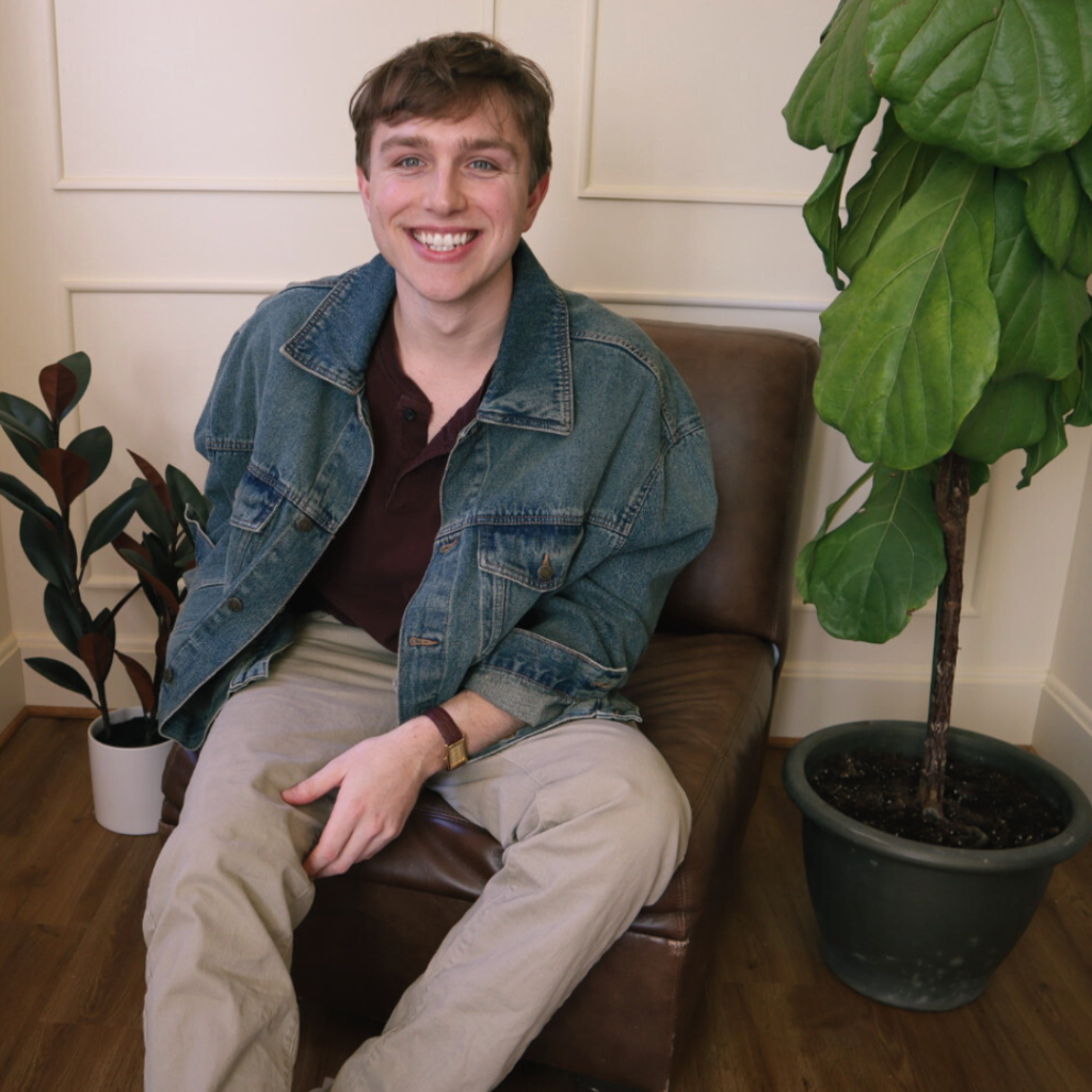 Smiling person sitting indoors