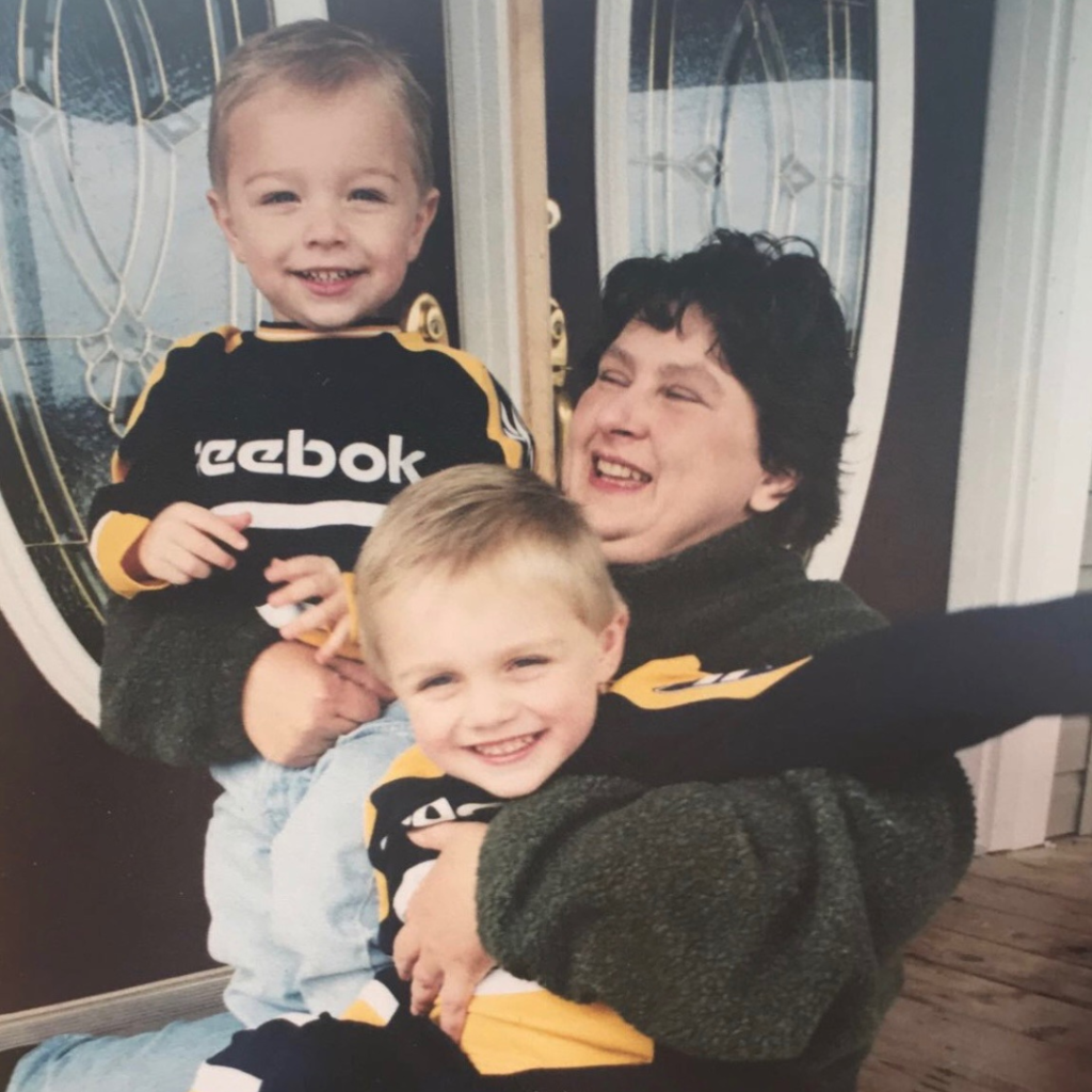 a woman holding two boys